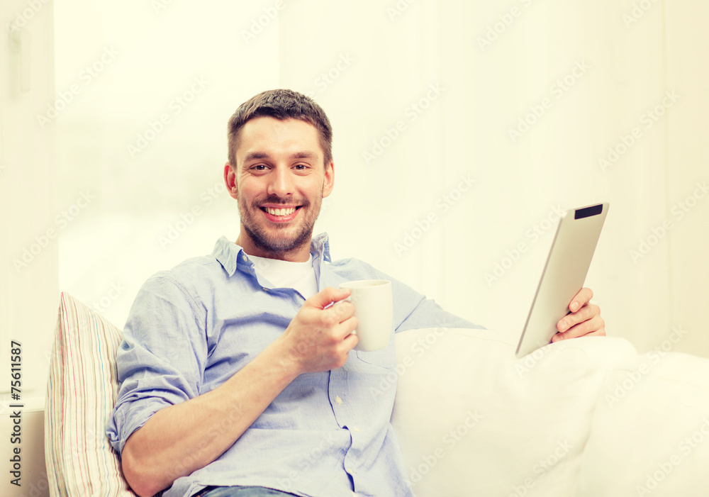 smiling man working with tablet pc at home smiling man working with tablet pc at home