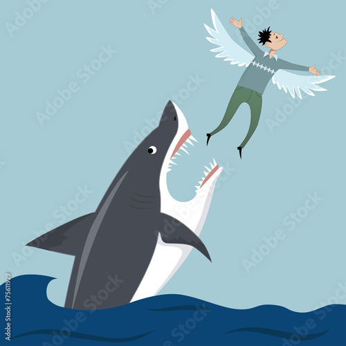 Man flying away from a shark