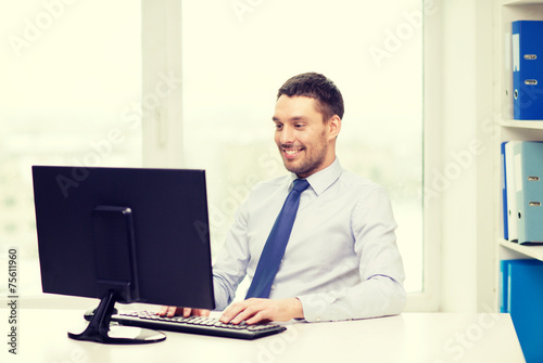 smiling businessman or student with computer © Syda Productions