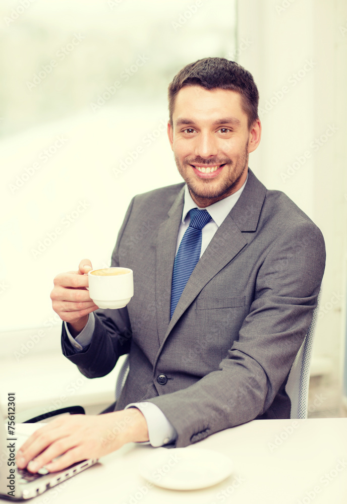 smiling businessman with laptop and coffee smiling businessman with laptop and coffee