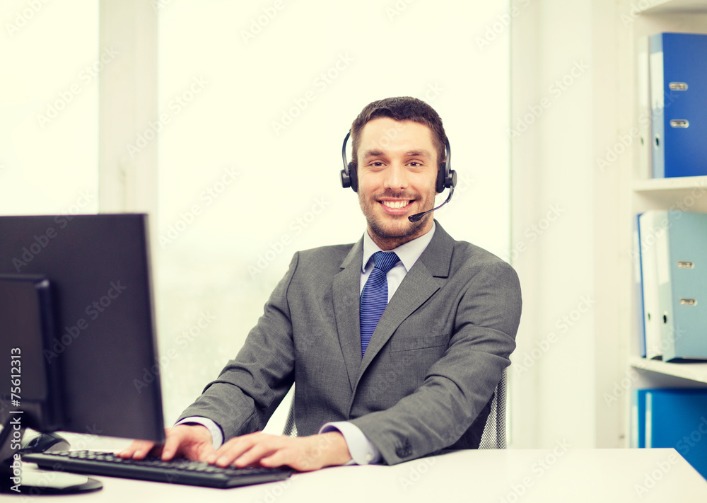 helpline operator with headphones and computer