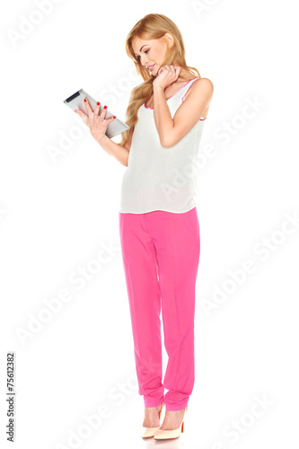 Girl in shirt and pants with tablet computer