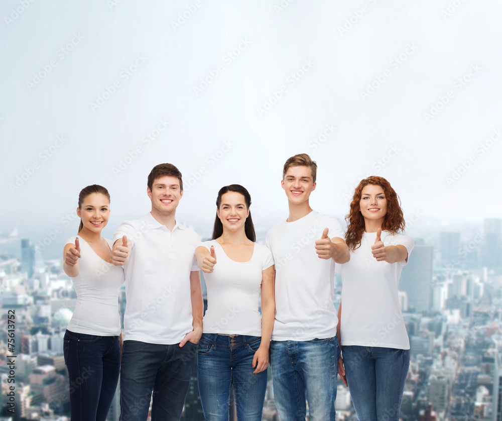 smiling teenagers in t-shirts showing thumbs up smiling teenagers in t-shirts showing thumbs up