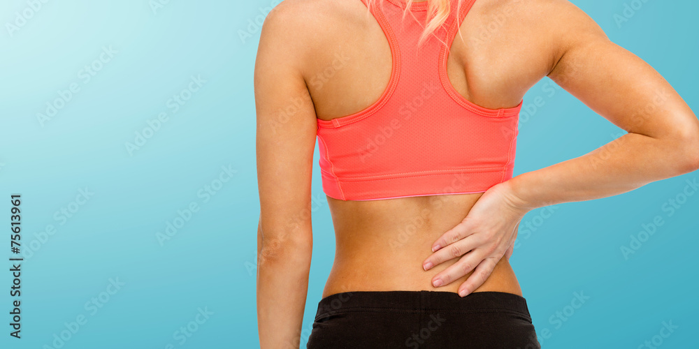 close up of sporty woman touching her back close up of sporty woman touching her back