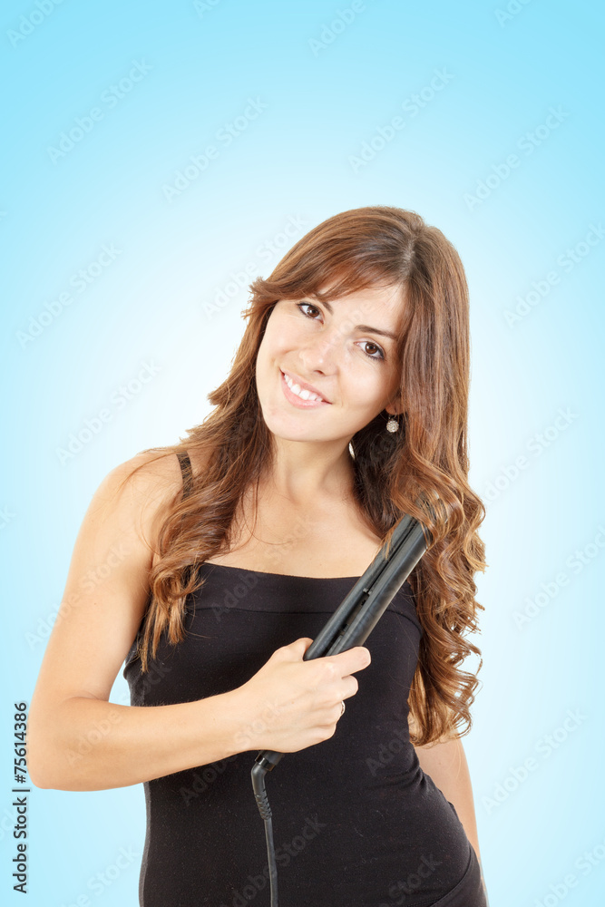 Young woman using curly iron on her hair Young woman using curly iron on her hair