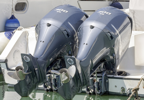 Pair of  blue chromed outboard engines installed on a white pleasure boat - find more in my portfolio  photo