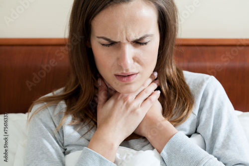 Woman having a sore throat