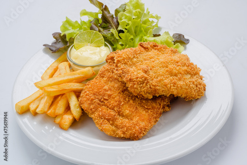 Breaded chicken with mashed potatoes and salad on a white backgr