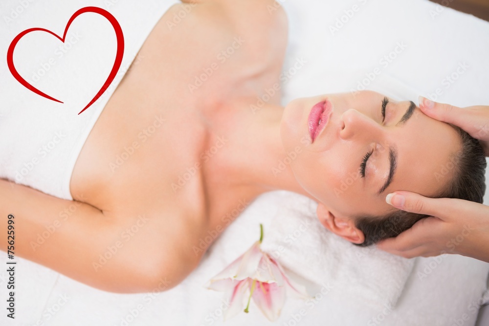 Attractive woman receiving head massage at spa center Attractive woman receiving head massage at spa center