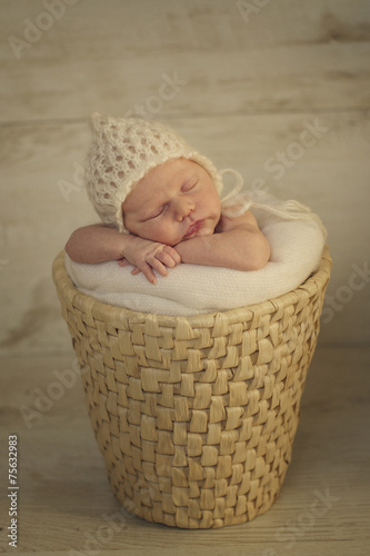 Portrait of Newborn Baby Sleeping on Hands in Basket