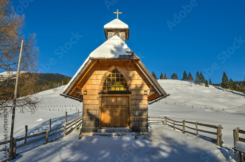 Chapel in the Alpine meadow in Winter photo