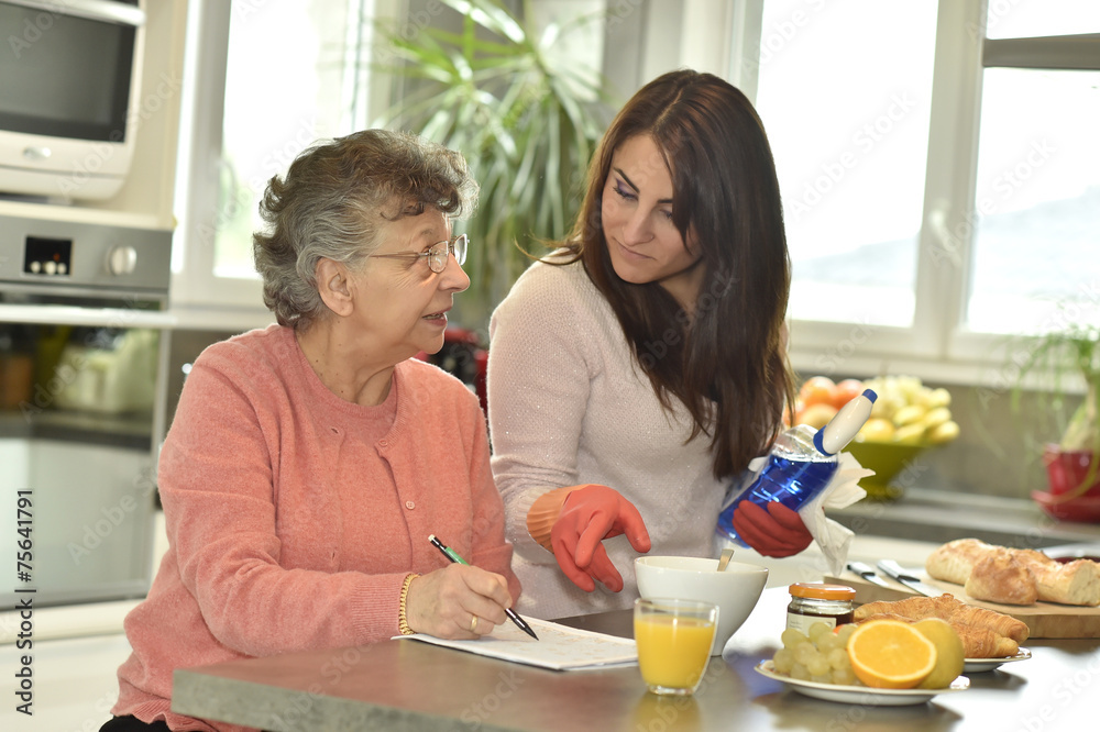 Homecare helping elderly woman doing crossword
