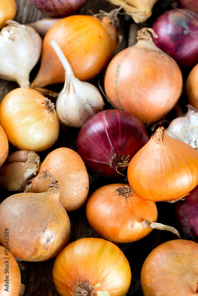 red and yellow onion on wooden surface red and yellow onion on wooden surface