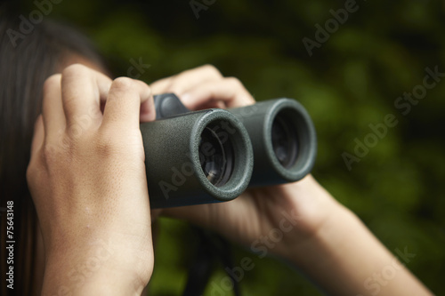 A young girl with bird watching binoculars. 