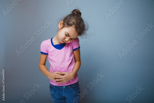 girl winced in pain holding his hands over stomach