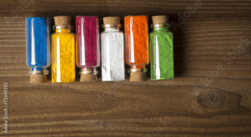 Glass bottles filled with coloured powder