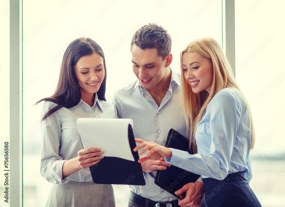 business team looking at clipboard business team looking at clipboard
