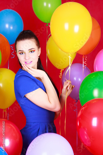 Portrait of a young attractive woman among many bright balloons © art_zzz