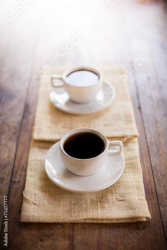 Two cups of coffee on brown napkin