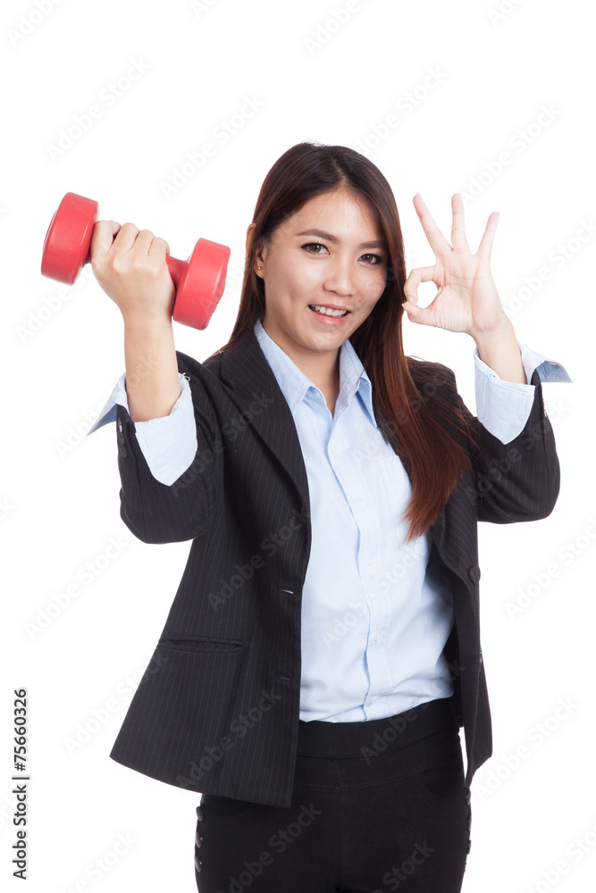 Young Asian businesswoman show OK with red dumbbell Young Asian businesswoman show OK with red dumbbell