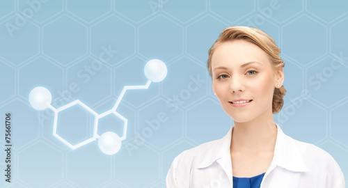 smiling female doctor with molecule of serotonin photo