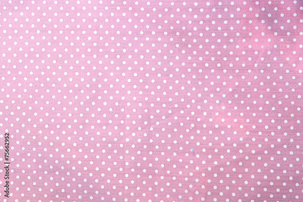 pink polka dot fabric closeup. May use as background