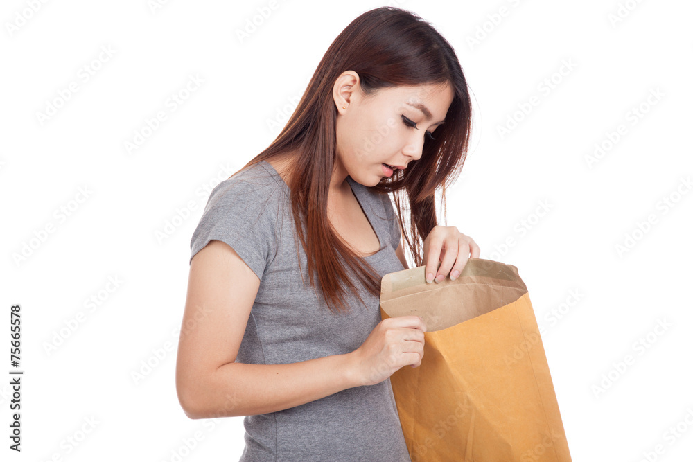 Young Asian woman surprise look inside brown envelope
