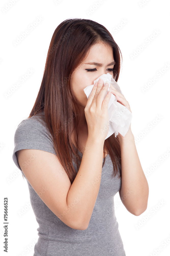Sick Young Asian woman using a tissue paper Sick Young Asian woman using a tissue paper