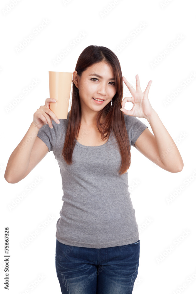 Young Asian woman show OK with tall plastic glass Young Asian woman show OK with tall plastic glass