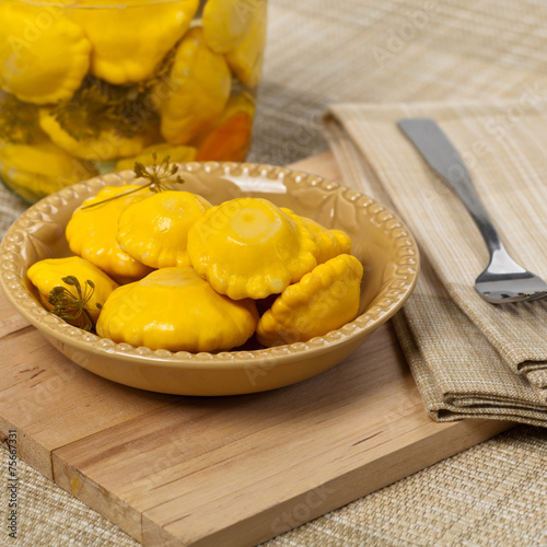 Pickled Yellow Pattypan Squash. Selective focus.