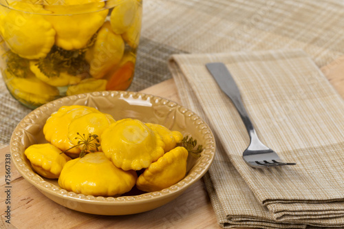 Pickled Yellow Pattypan Squash. Selective focus.