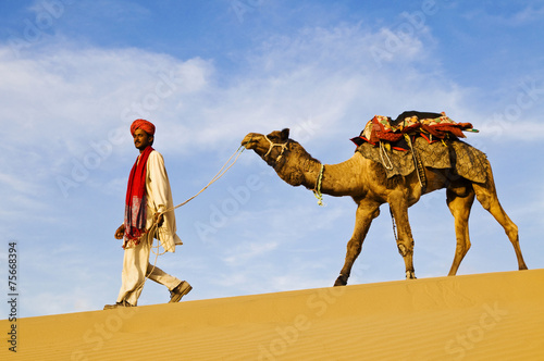 Indigenous Indian Man Walking Desert Camel Concept photo
