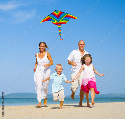 Family running on the beach