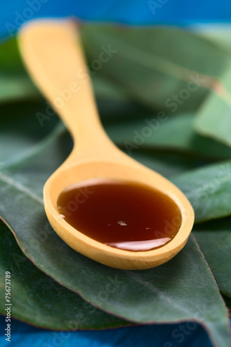 Eucalyptus cough syrup on spoon on Eucalyptus leaves