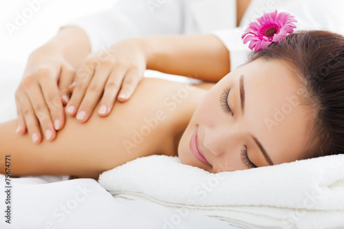 young woman in spa salon getting massage