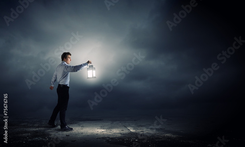 Businessman in search in darkness
