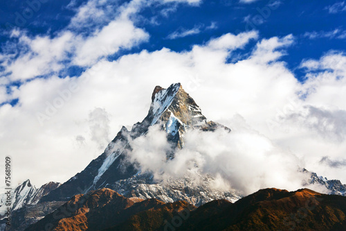 Machapuchare mount over clouds, Nepal photo