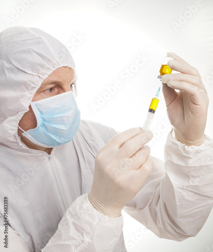 Man with syringe and vial photo