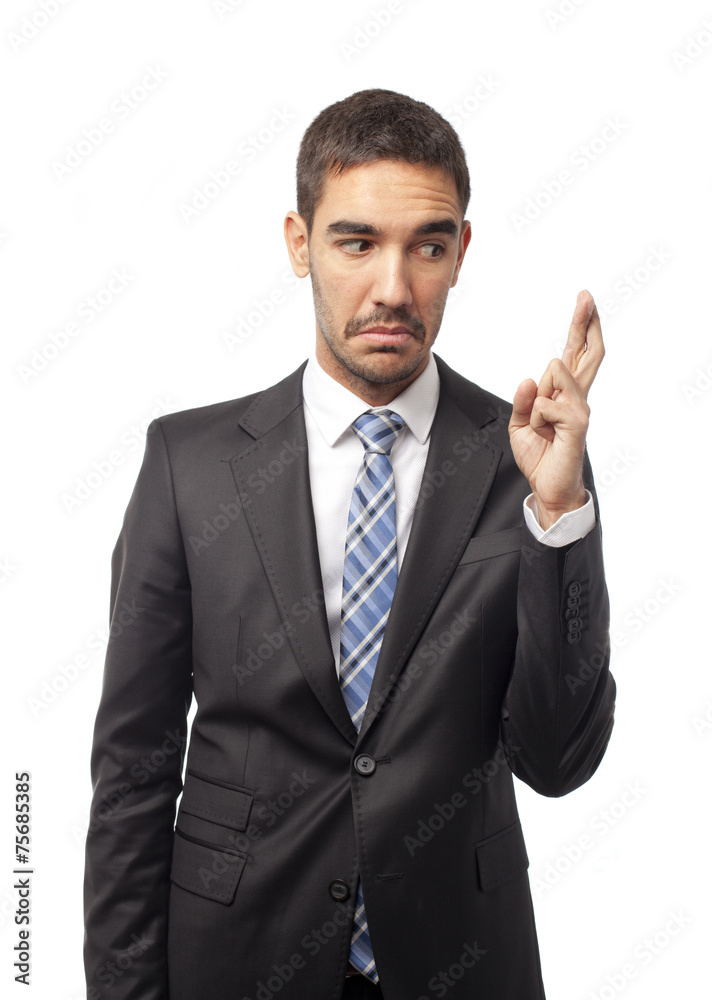 Concerned businessman with fingers crossed Concerned businessman with fingers crossed