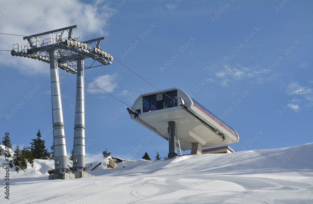 Fototapeta premium Ropeway in snow mountain under blue sky