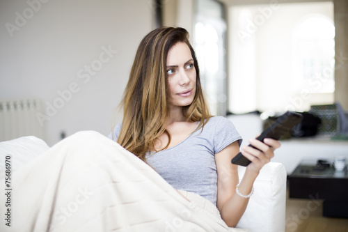 Young woman with remote con...