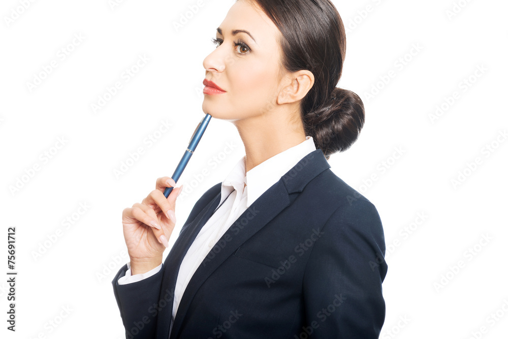Portrait of businesswoman holding pen under chin Portrait of businesswoman holding pen under chin