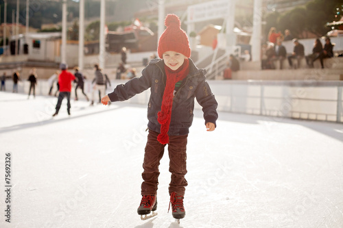 Happy boy with red hat, skating during the day