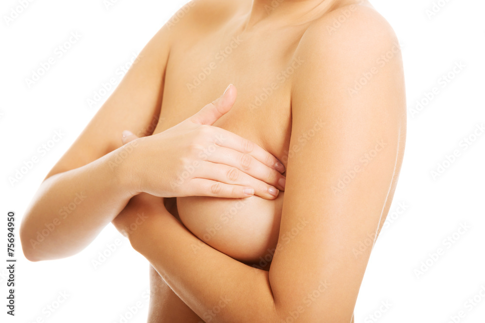 Fototapeta premium Nude woman examining her breast