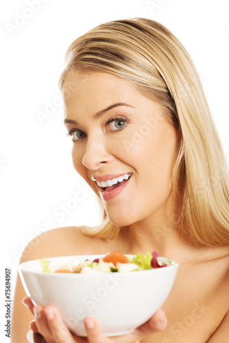 Woman holding a bowl with salad