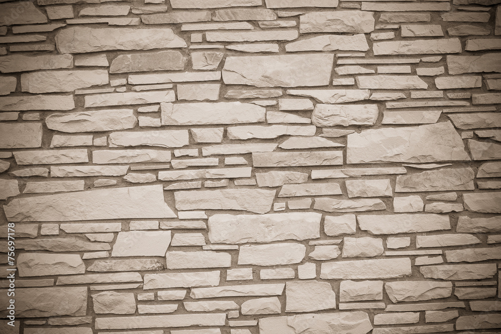 A dry stone wall made of random grey stone. wall of stones A dry stone wall made of random grey stone. wall of stones
