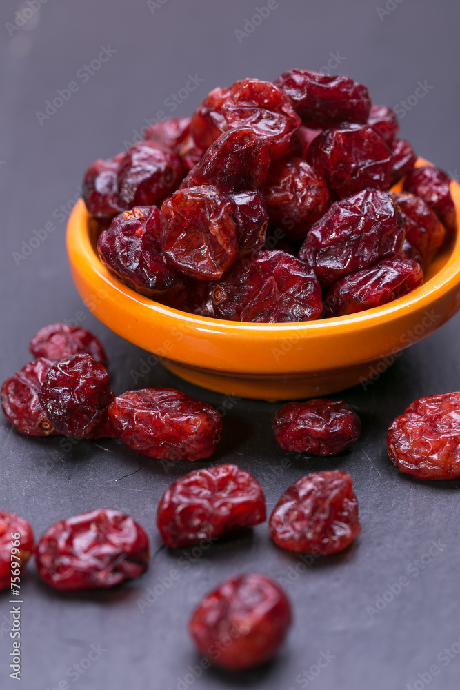 dried cranberries in a wooden spoon. fruit full of vitamin c. dried cranberries in a wooden spoon. fruit full of vitamin c.