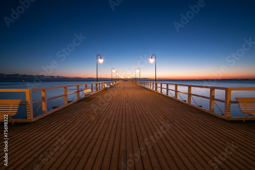 Fototapeta Naklejka Na Ścianę i Meble -  Beautiful colorful Sunrise on the pier at the seaside