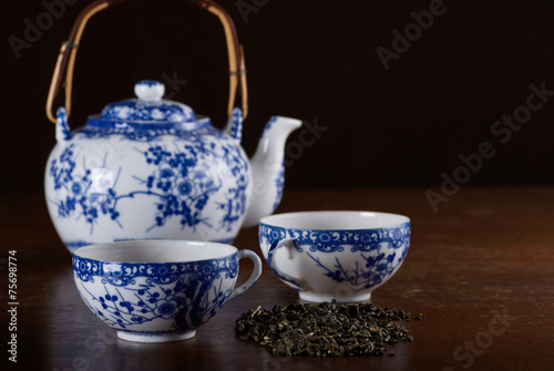 Photography Old Chinese porcelain teapot with two cups