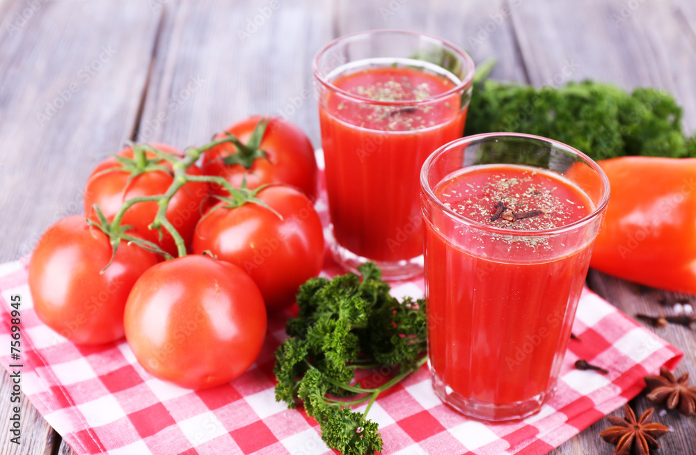 Tomato juice in glasses and fresh vegetables Tomato juice in glasses and fresh vegetables